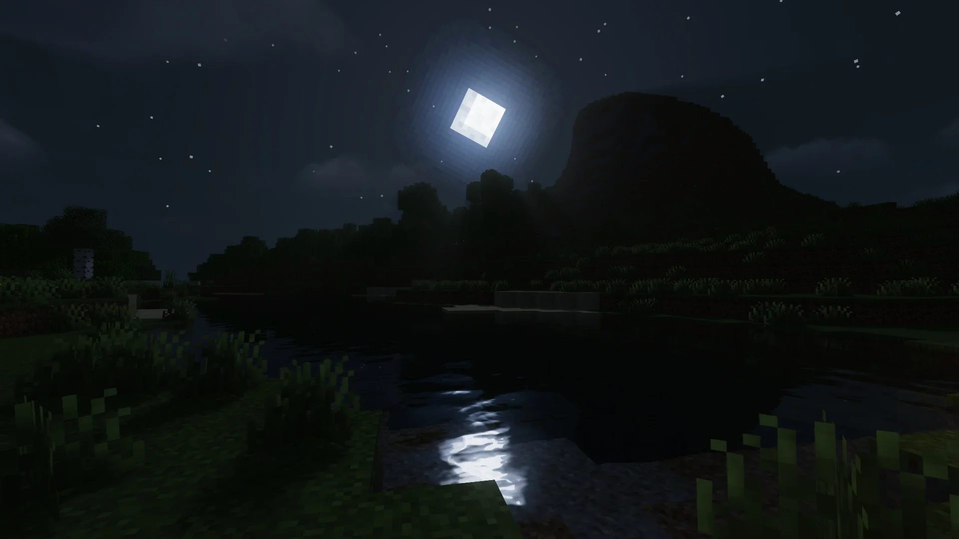 Moon and stars over a dark lakeshore with water reflections