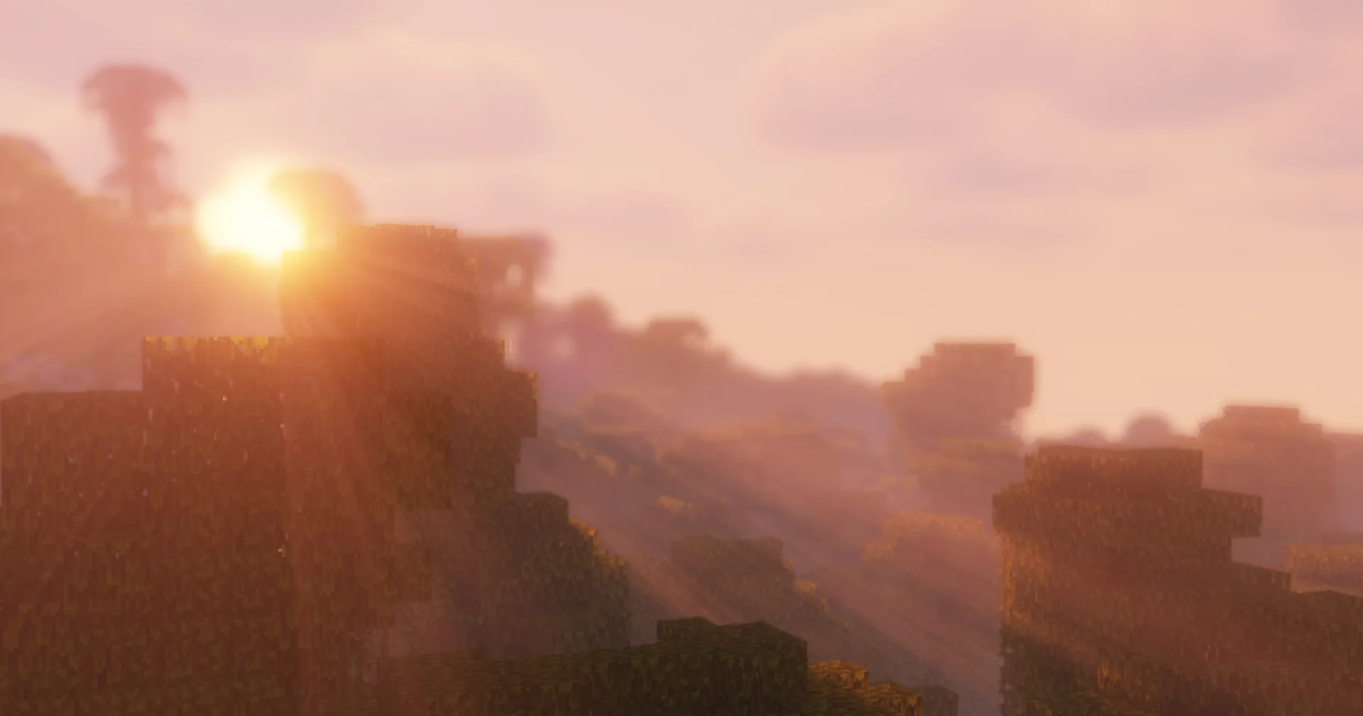 Sunrise with volumetric light rays over hilly terrain